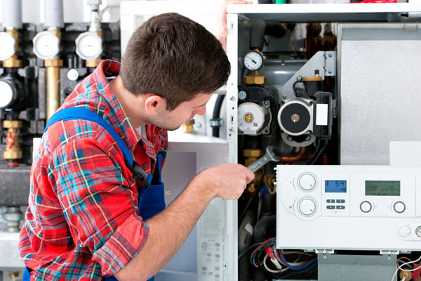 Heating technician repairing boiler controls in Hayward