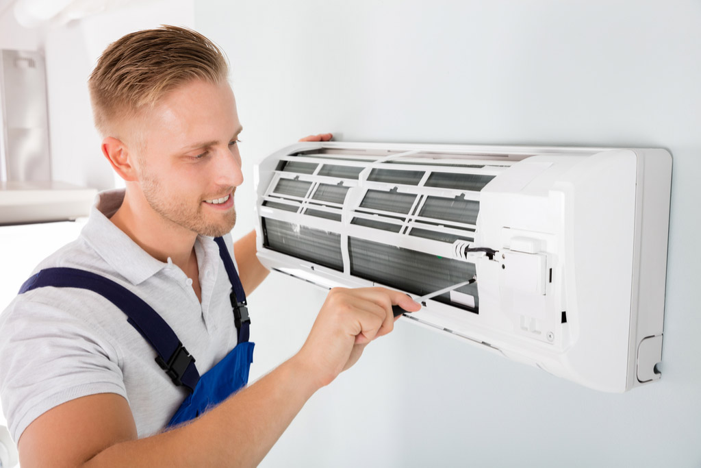 HVAC technician maintaining a ductless air conditioner in Hayward