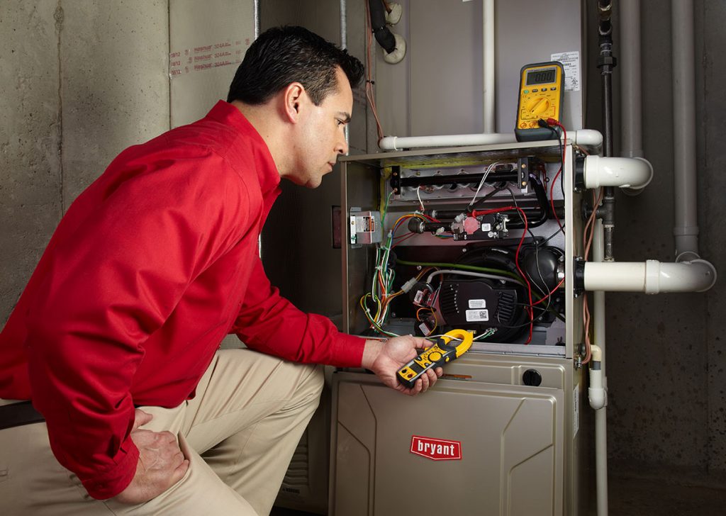 Heating technician diagnosing a furnace repair in Hayward