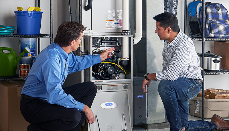 Technician evaluating a furnace for repair or replacement in Hayward