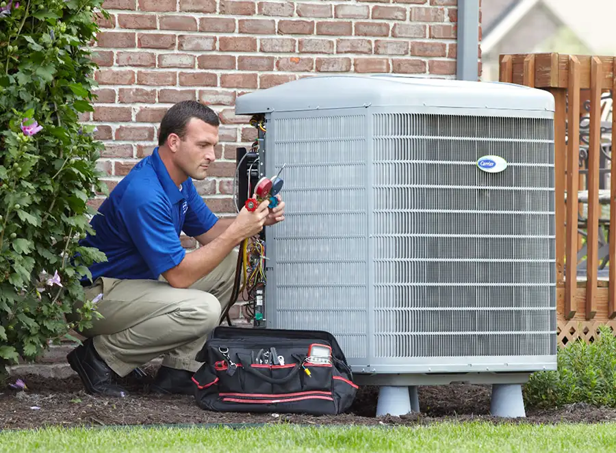 HVAC technician inspecting an outdoor AC unit in Hayward